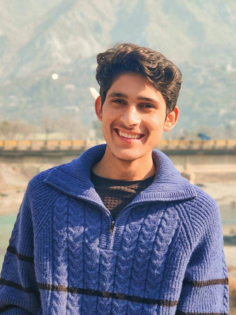 Smiling young man in a blue sweater